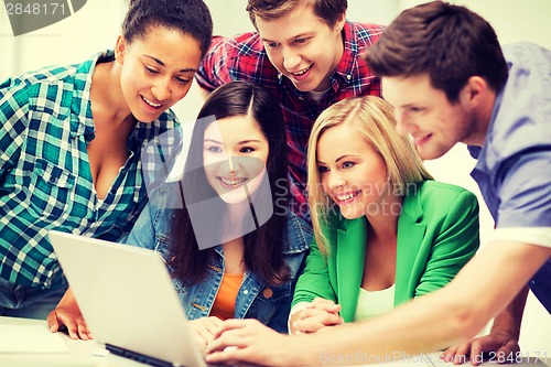 Image of students looking at tablet pc in lecture at school