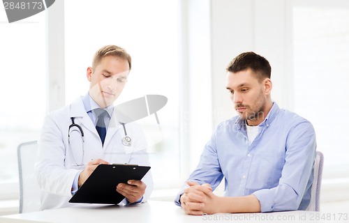 Image of doctor with clipboard and patient in hospital