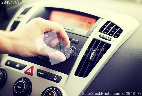 Image of man using car audio stereo system