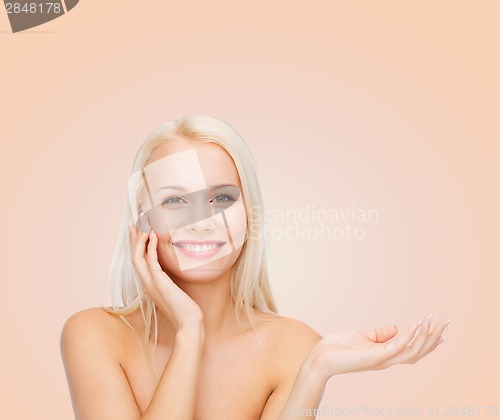 Image of smiling woman holding imaginary lotion jar