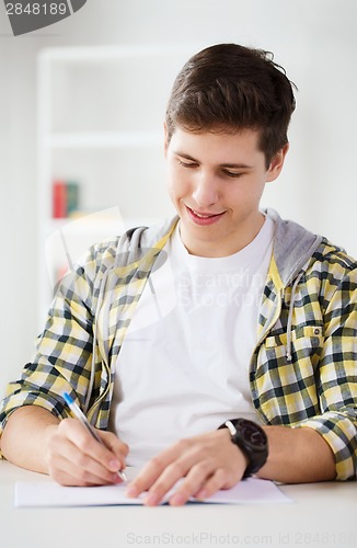 Image of smiling student with textbooks at school