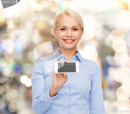 Image of smiling businesswoman with smartphone blank screen