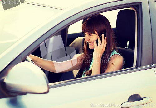 Image of woman using phone while driving the car