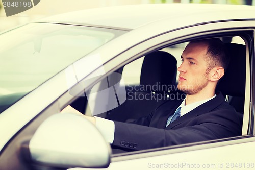 Image of businessman driving a car