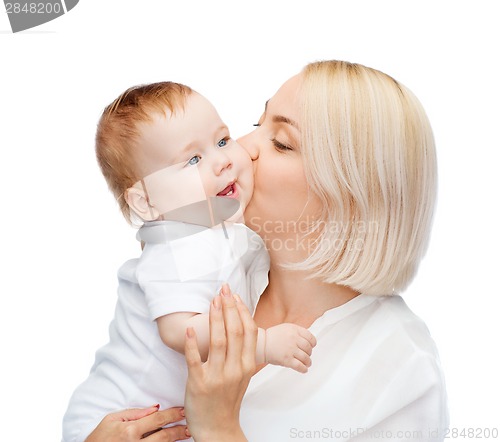 Image of happy mother kissing smiling baby