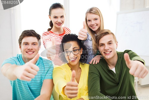 Image of smiling students at school showing thumbs up