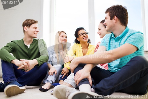 Image of five smiling teenagers having fun at home