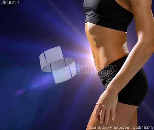 Image of close up of athletic female abs in sportswear