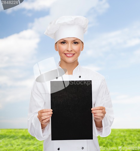 Image of smiling female chef with black blank paper