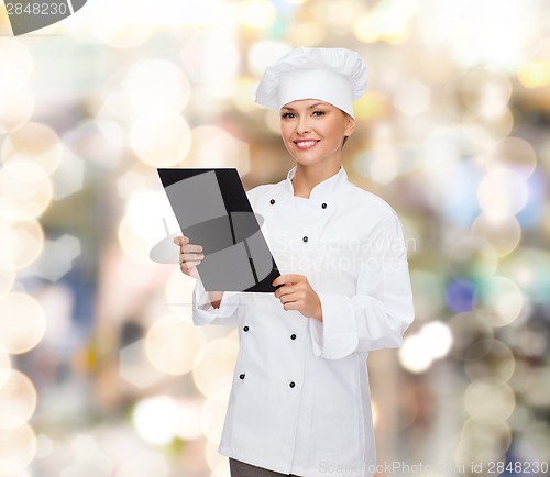 Image of smiling female chef with black blank paper