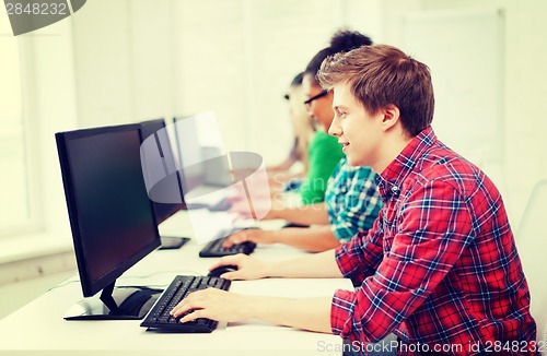 Image of student with computer studying at school