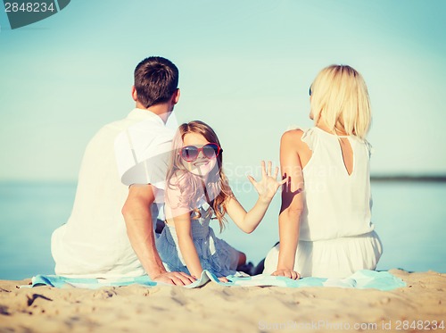 Image of happy family on the beach