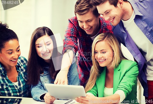Image of students looking at tablet pc in lecture at school