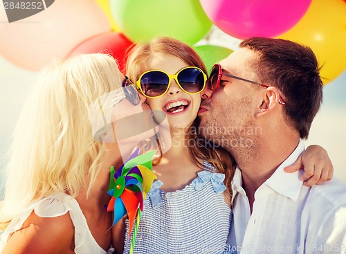 Image of family with colorful balloons