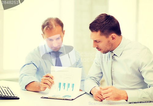 Image of businessmen with notebook on meeting