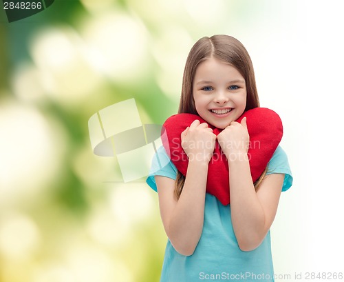 Image of smiling little girl with red heart