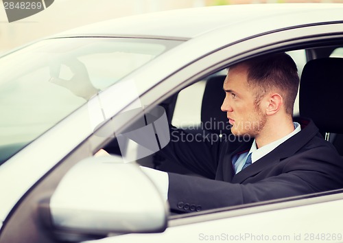 Image of businessman driving a car