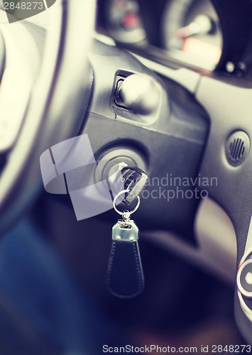 Image of car key in ignition start lock