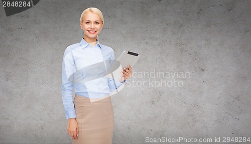 Image of smiling woman looking at tablet pc computer