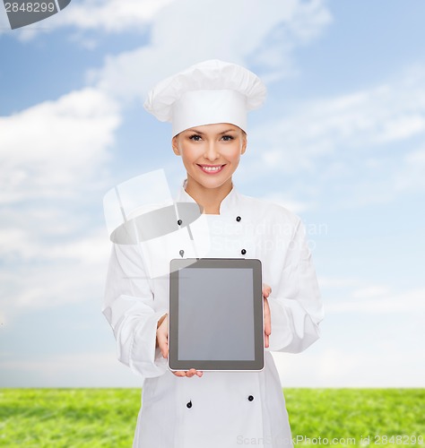 Image of smiling female chef with tablet pc blank screen