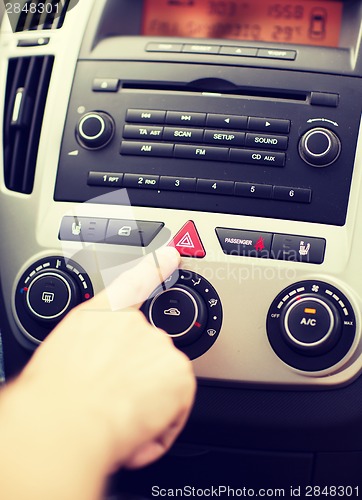 Image of man pressing car hazard warning button