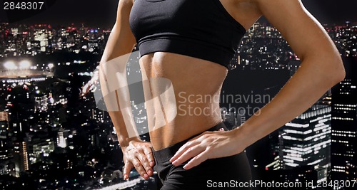 Image of close up of athletic female abs in sportswear