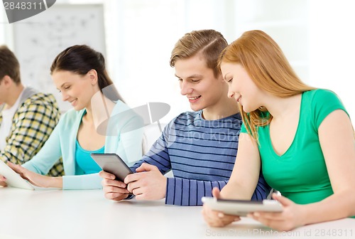 Image of smiling students with tablet pc at school