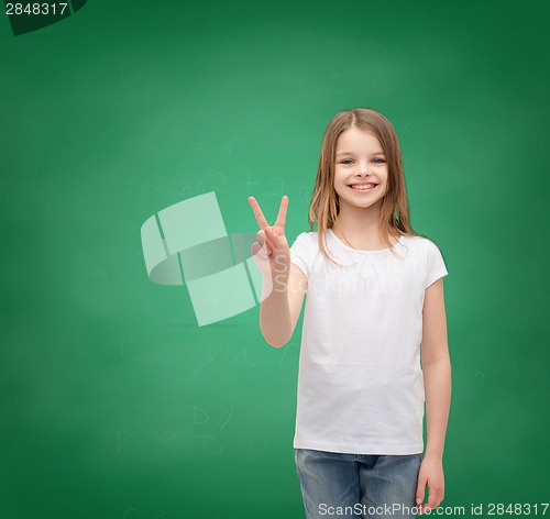 Image of little girl in white t-shirt showing peace gesture