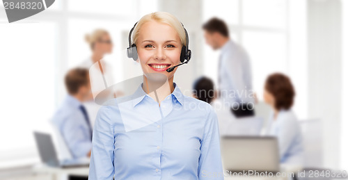 Image of friendly female helpline operator with headphones