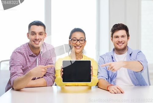 Image of smiling colleagues showing tablet pc blank screen