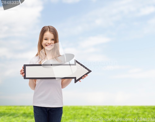 Image of smiling girl with blank arrow pointing right