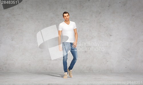 Image of smiling young man in white t-shirt