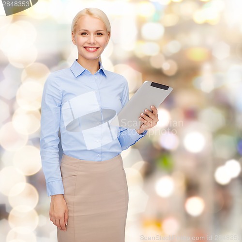 Image of smiling woman looking at tablet pc computer