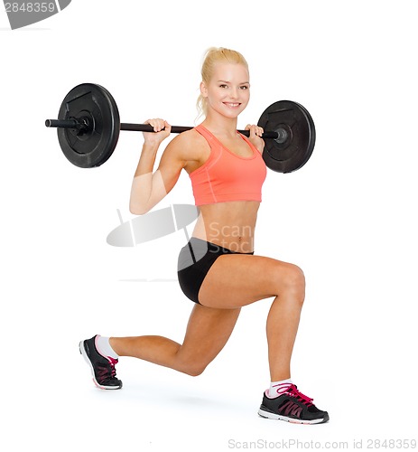 Image of smiling sporty woman exercising with barbell