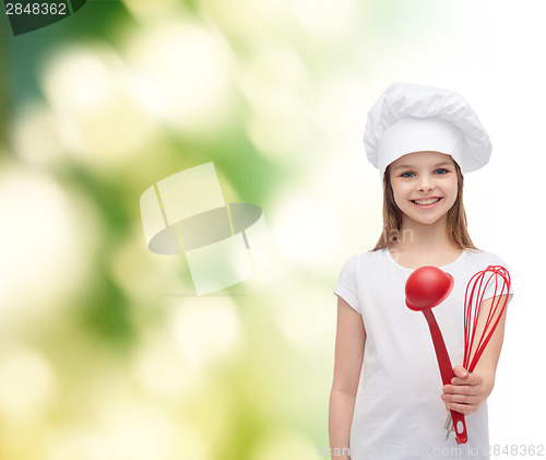 Image of smiling girl in cook hat with ladle and whisk