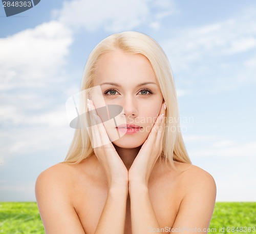 Image of beautiful woman touching her face skin