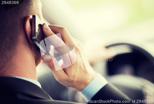 Image of man using phone while driving the car