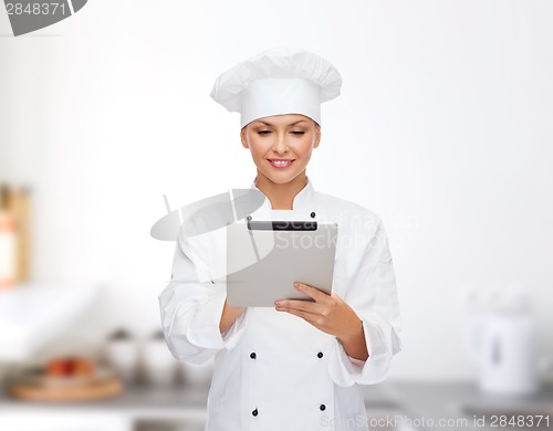 Image of smiling female chef with tablet pc computer