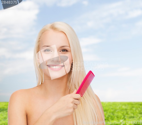 Image of smiling woman with hair brush