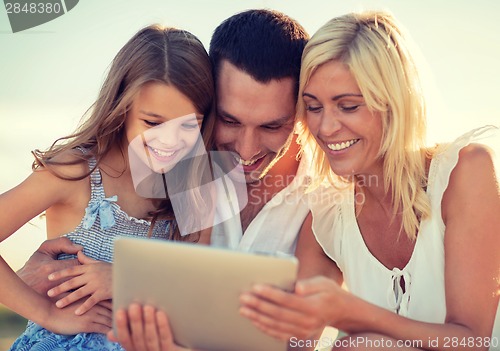 Image of happy family with tablet pc taking picture