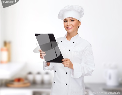 Image of smiling female chef with black blank paper