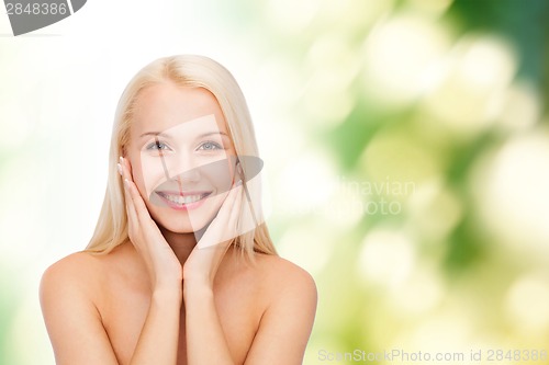 Image of beautiful woman touching her face skin