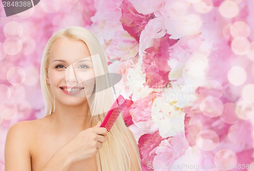 Image of smiling woman with hair brush