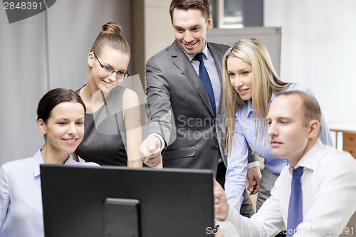 Image of business team with monitor having discussion