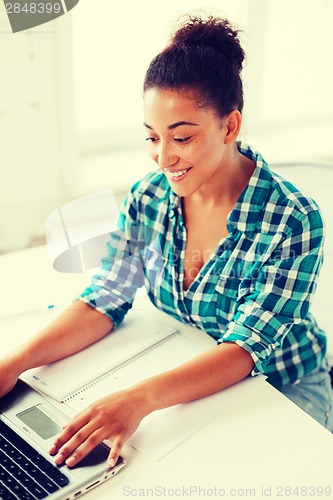 Image of international student girl with laptop at school