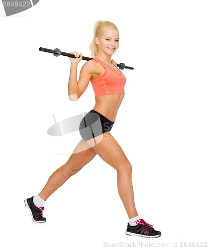 Image of smiling sporty woman exercising with barbell