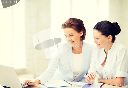 Image of businesswomen working with laptop in office