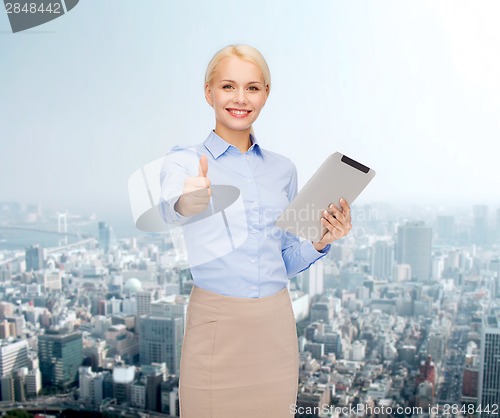 Image of smiling woman looking at tablet pc computer