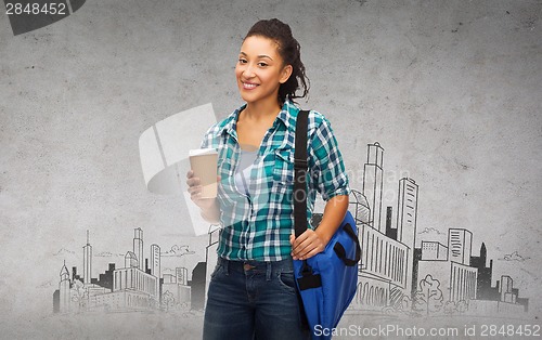 Image of smiling student with bag and take away coffee cup