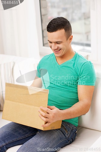 Image of man with cardboard boxes at home